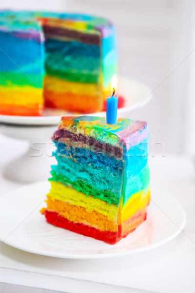 Szivárvány torta díszített születésnap gyertya közelkép Stock fotó © dashapetrenko