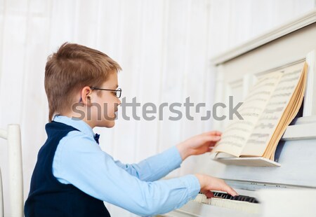 Little boy playing piano at home Stock photo © dashapetrenko