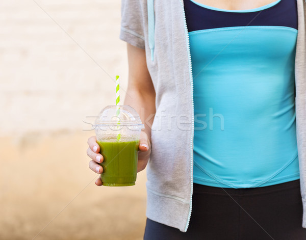 Stock photo: Woman drinking vegetable smoothie after fitness running workout 