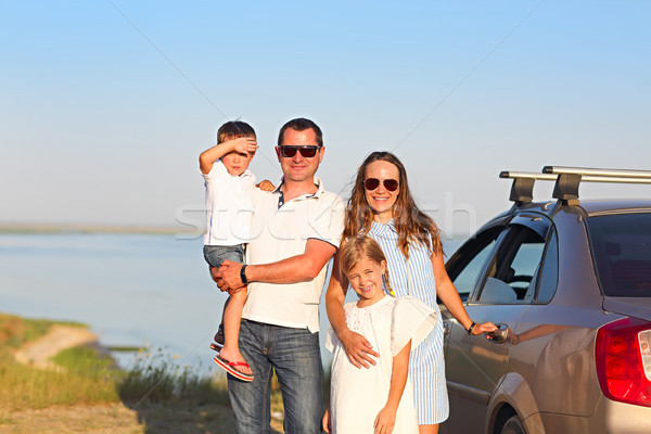 Happy smiling family with two kids by the car with sea backgroun Stock photo © dashapetrenko