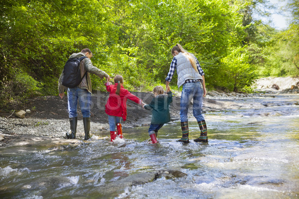 Young family with two little daughters on mountain trek Stock photo © dashapetrenko