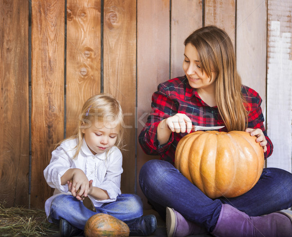 Mother and her little daughter carving Halloween pumpkins  Stock photo © dashapetrenko