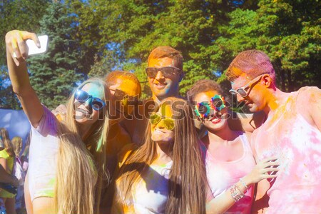Happy friends on holi color festival Stock photo © dashapetrenko