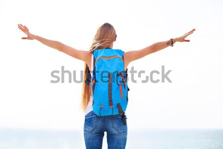 Young blonde girl with raised arms at sea shore Stock photo © dashapetrenko