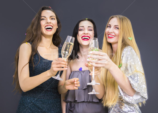 Three young woman having fun with champagne Stock photo © dashapetrenko