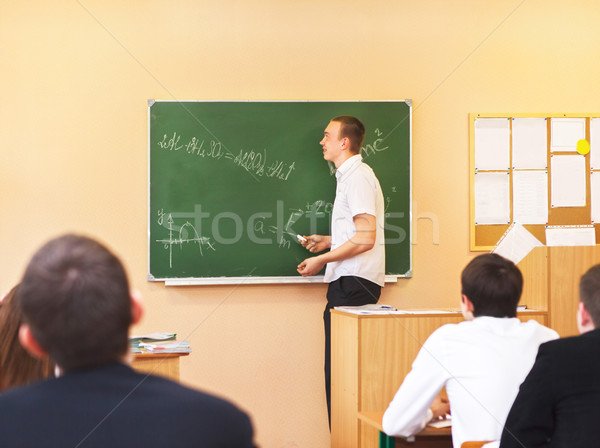 Rear view of students attentively listening to male student  Stock photo © dashapetrenko