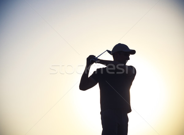 Stock photo: Male golfer at sunset