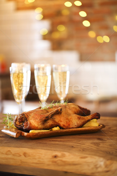 Stock photo: Winter holiday family dinner with roast poultry and champagne