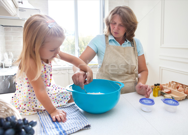 Little girl baking with her grandmother at home Stock photo © dashapetrenko