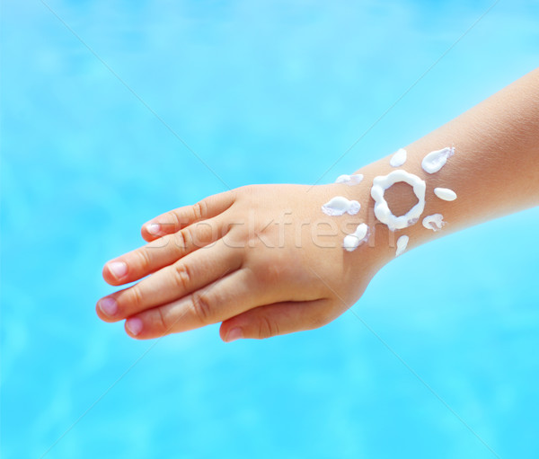 Little hand of the baby with suntan lotion near the pool  Stock photo © dashapetrenko