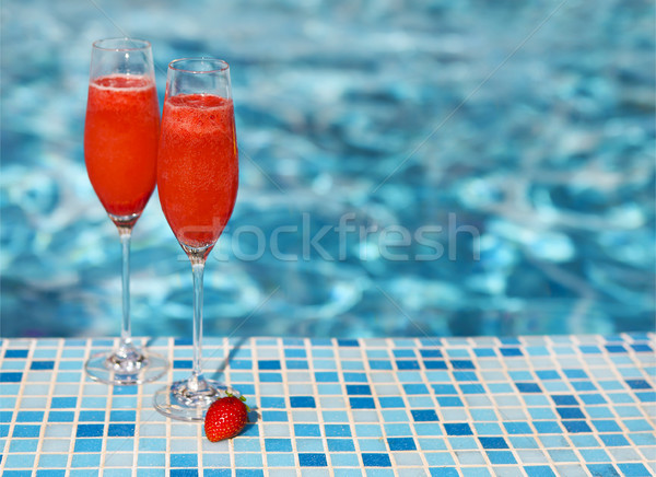 Champagne glasses with strawberry. Rossini cocktail. Summer pool Stock photo © dashapetrenko