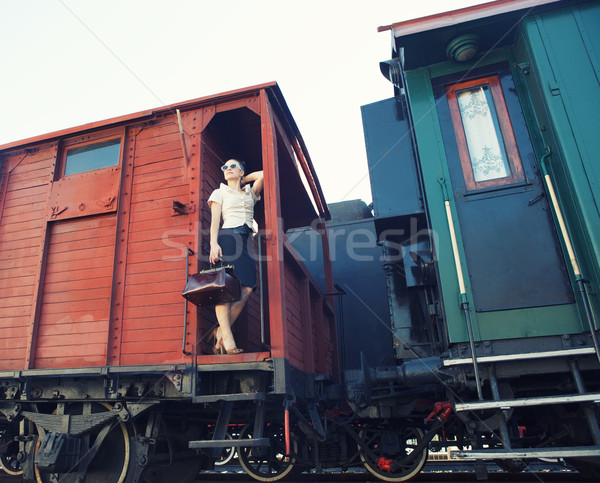 Woman with a suitcase standing on the train Stock photo © dashapetrenko