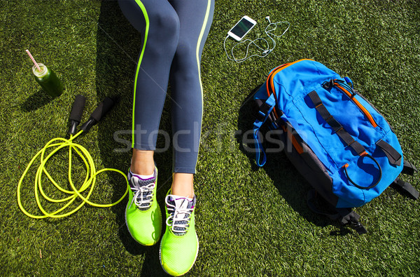 Sporty woman sitting on the green grass Stock photo © dashapetrenko