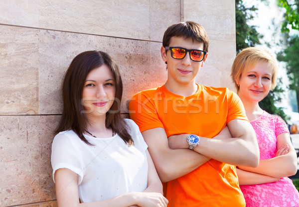 Group of smiling teenagers sitting outdoors Stock photo © dashapetrenko