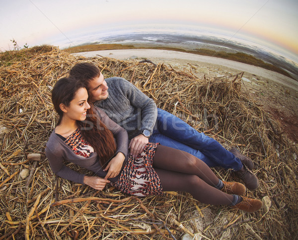 Happy young couple lying down smiling at autumn background Stock photo © dashapetrenko