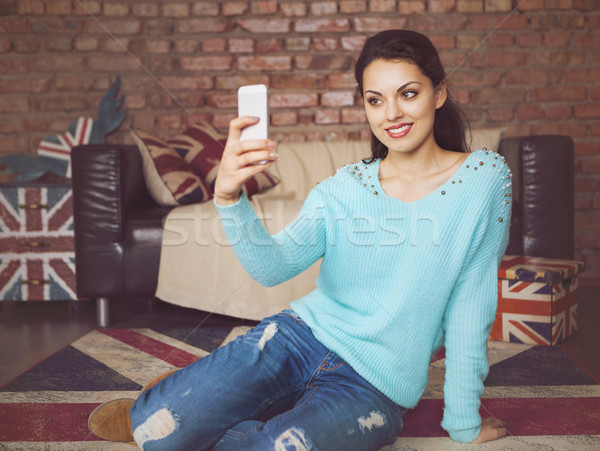 Young beautiful woman sitting with smart phone Stock photo © dashapetrenko