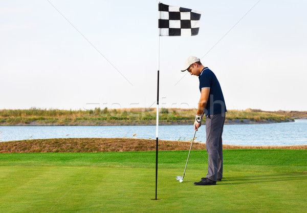 Sportlich junger Mann spielen Golf Club Wasser Stock foto © dashapetrenko