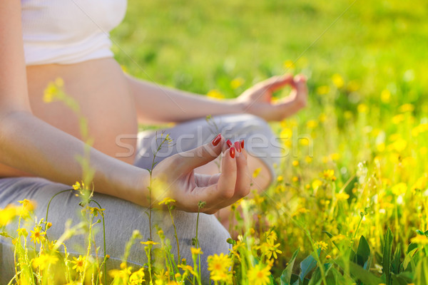 Healthy pregnant woman doing yoga in nature outdoors Stock photo © dashapetrenko