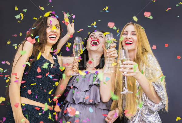 Three young woman having fun with champagne Stock photo © dashapetrenko