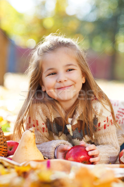 Adorable little girl with autumn leaves and apple Stock photo © dashapetrenko