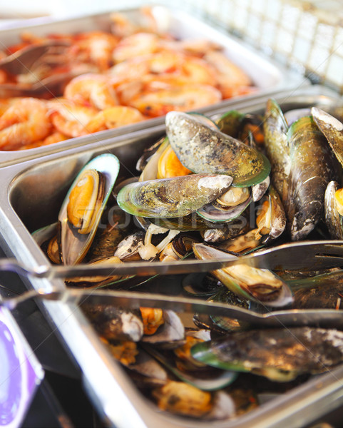 Stock photo: Buffet table with seafood with shrimps, fried calamari rings and