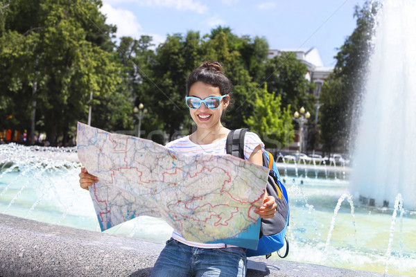 Tourist woman searching direction on location map Stock photo © dashapetrenko