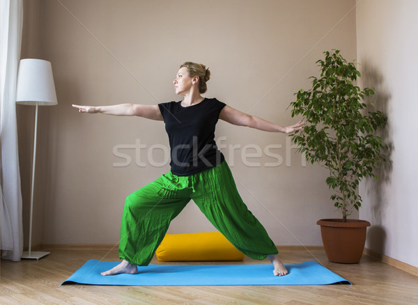 Middle aged woman doing yoga indoors Stock photo © dashapetrenko