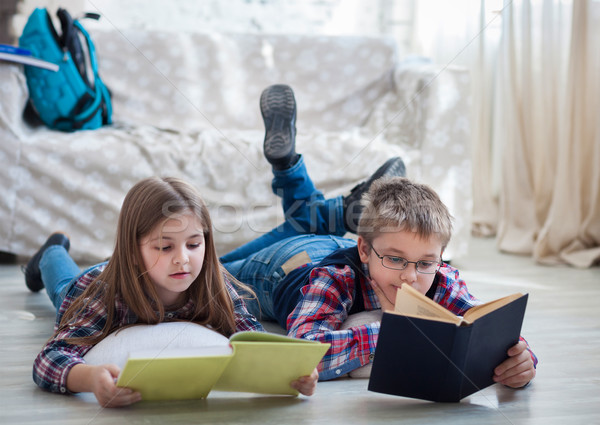 Children readind book in living room Stock photo © dashapetrenko