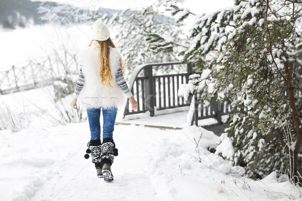 Young woman walking at park covered with snow Stock photo © dashapetrenko