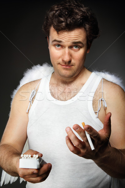 Mr. Angel with cigarettes. Stock photo © dashapetrenko