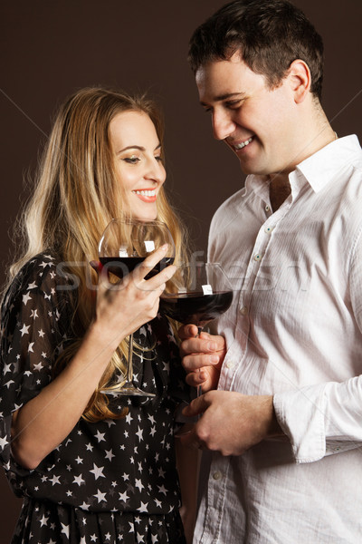 Young happy couple enjoying a glasses of wine Stock photo © dashapetrenko