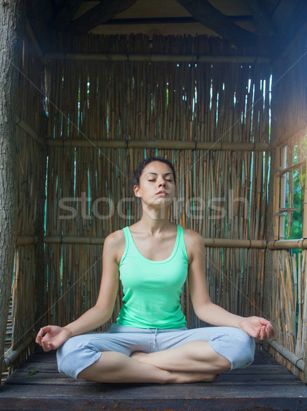 Young woman doing yoga asana in the evening Stock photo © dashapetrenko