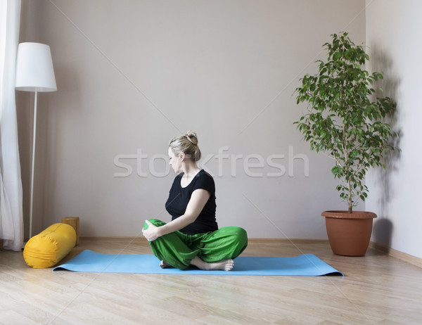 Middle aged woman doing yoga indoors Stock photo © dashapetrenko