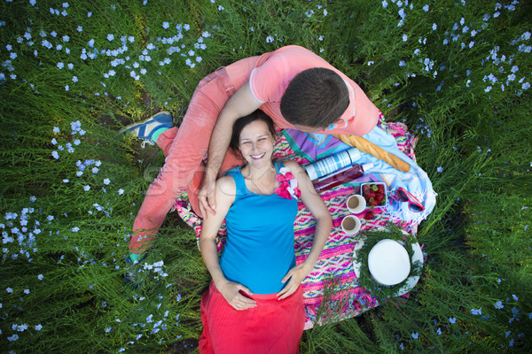 Young happy beautiful pregnant couple in linen field Stock photo © dashapetrenko
