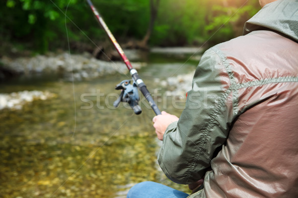 Fisherman with fly-fishing on mountain river Stock photo © dashapetrenko