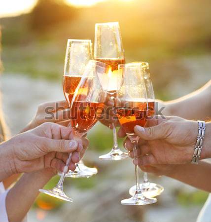 People holding glasses of white wine making a toast Stock photo © dashapetrenko