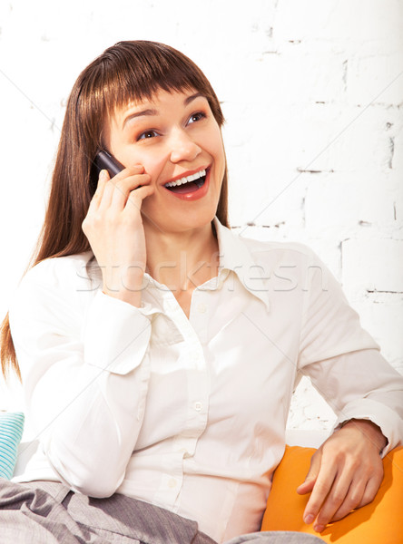 Young brunette woman talks on cell phone  Stock photo © dashapetrenko