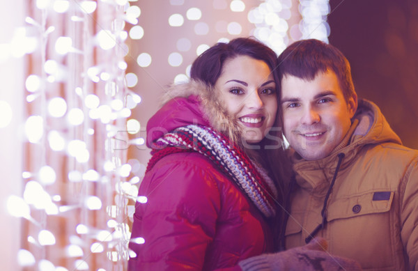 Happy couple in love outdoor in evening Christmas lights Stock photo © dashapetrenko