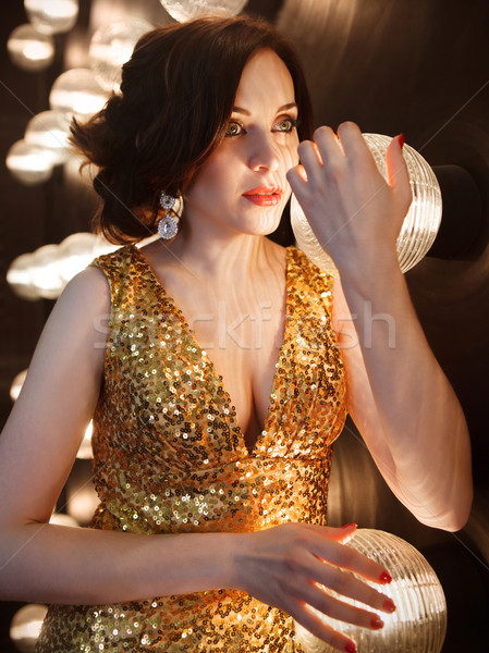 Szupersztár nő visel arany ragyogó ruha Stock fotó © dashapetrenko