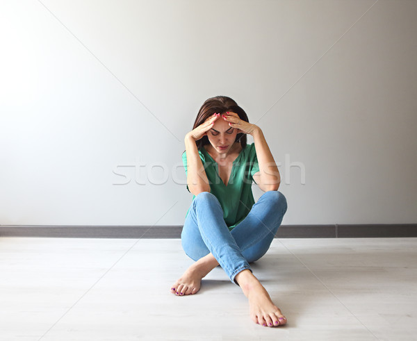 Sad woman looking thoughtful about her troubles in front of a gr Stock photo © dashapetrenko