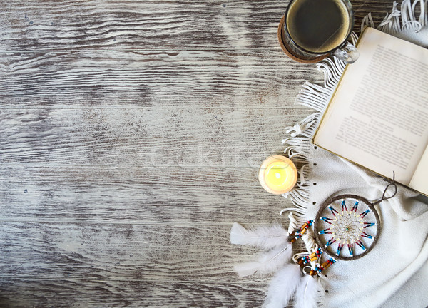 Cup of coffee staying by the book, candle, dream catcher on the  Stock photo © dashapetrenko