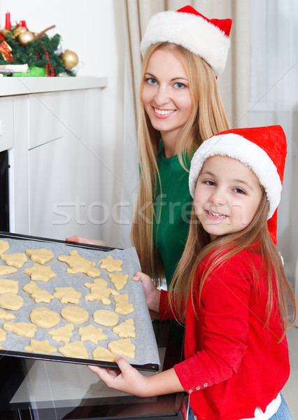 Little girl with her mother baking Christmas cookies Stock photo © dashapetrenko