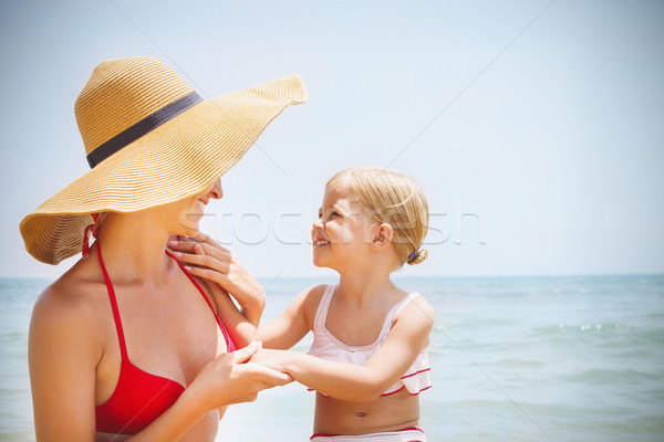 Happy mother and her baby daughter on sea coast Stock photo © dashapetrenko
