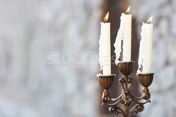  Candelabrum with three candles on grey background Stock photo © dashapetrenko