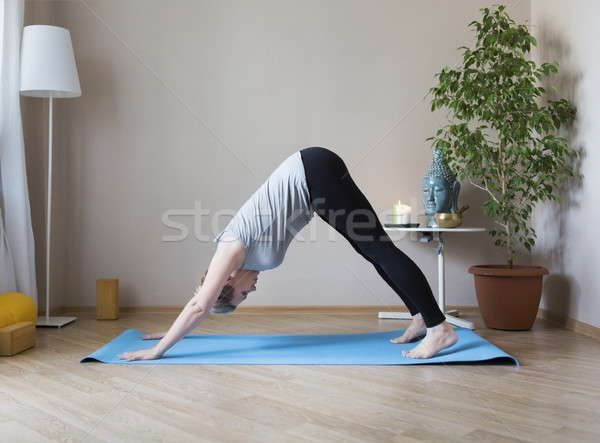 Middle aged woman doing yoga indoors Stock photo © dashapetrenko