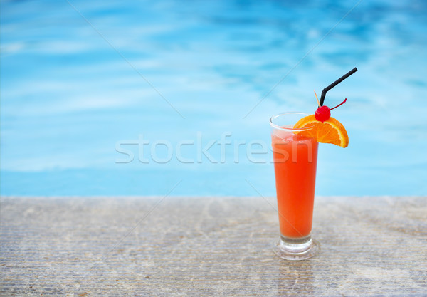 Glass of tropical cocktail on poolside Stock photo © dashapetrenko