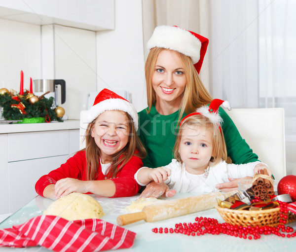 Two girls with mother baking Christmas cookies in the kitchen Stock photo © dashapetrenko