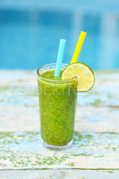 Freshly blended green fruit smoothie in glass with straw Stock photo © dashapetrenko