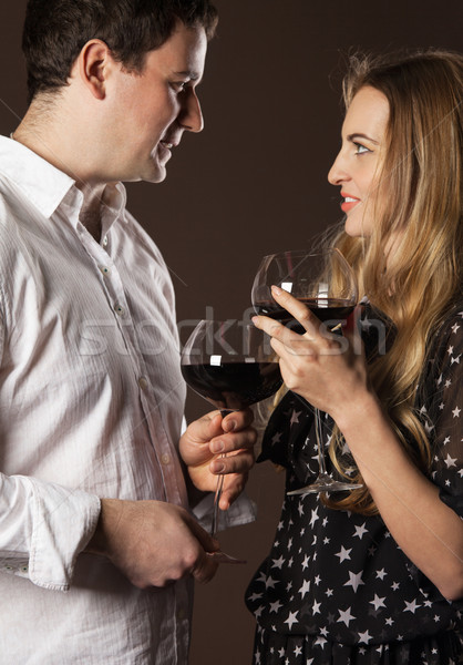 Young happy couple enjoying a glasses of wine Stock photo © dashapetrenko