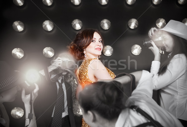 Superstar woman wearing golden shining dress  Stock photo © dashapetrenko